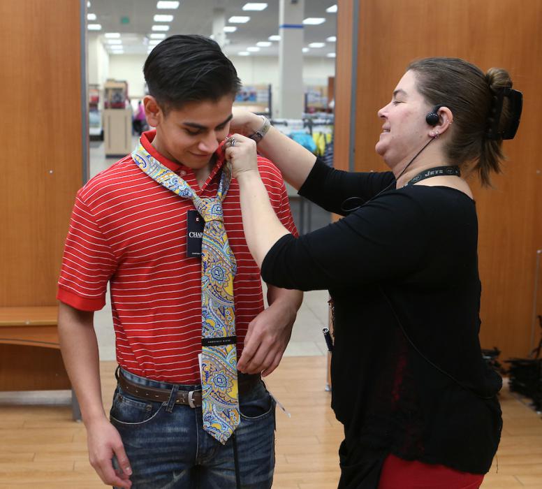 Jessica Lawrence helps Adrian Barrera, a WNC Business Association member, learn how to dress for success at recent training.