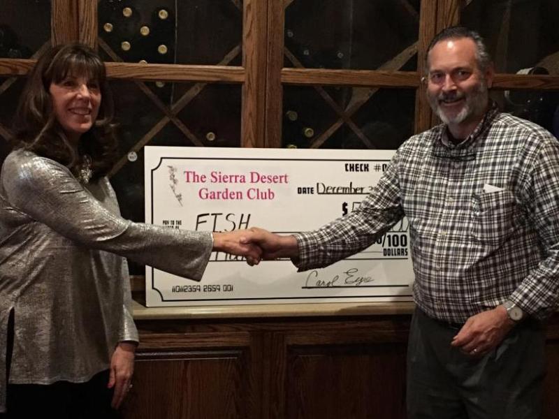 Susan McAfee, President presents check to Jim Peckham, executive director of FISH.