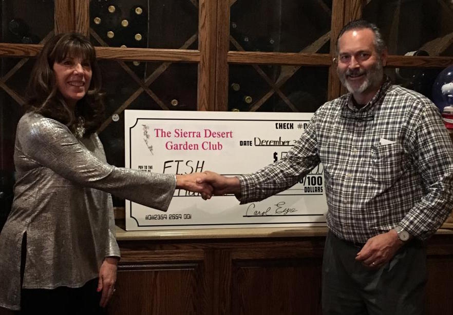 Susan McAfee, President presents check to Jim Peckham, executive director of FISH.