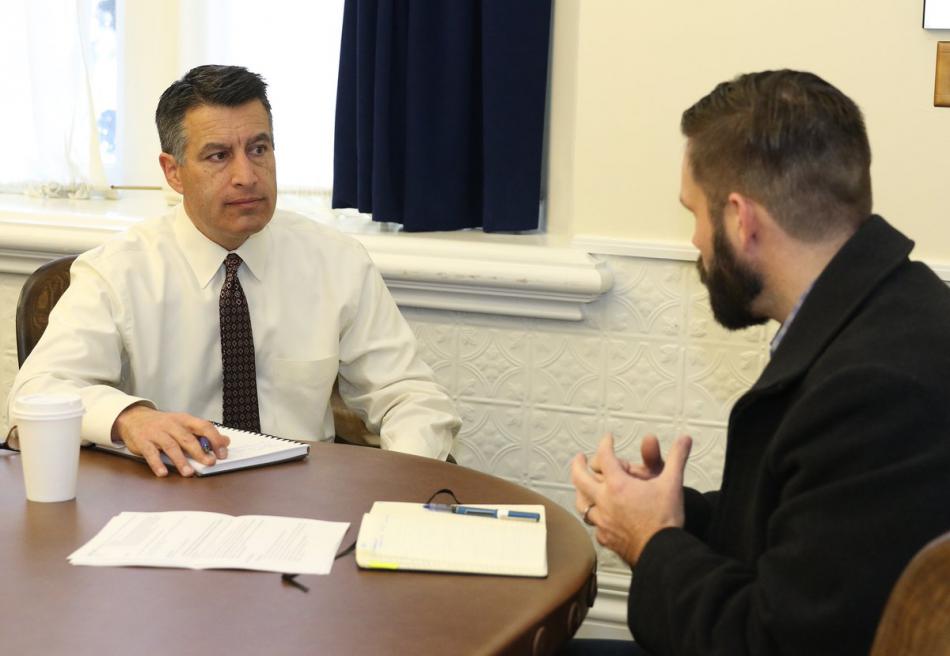 Nevada Gov. Brian Sandoval receives a briefing from emergency managers Friday. 