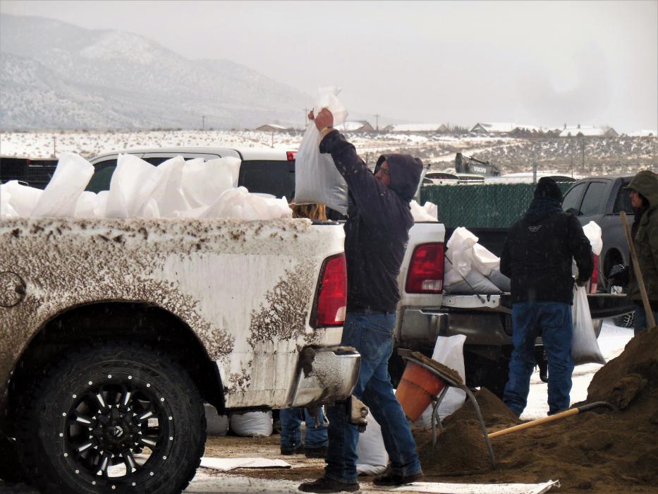 Photos by Brett Fisher. Carson City residents fill sandbags at the city public works yard off Butti Way Saturday morning.