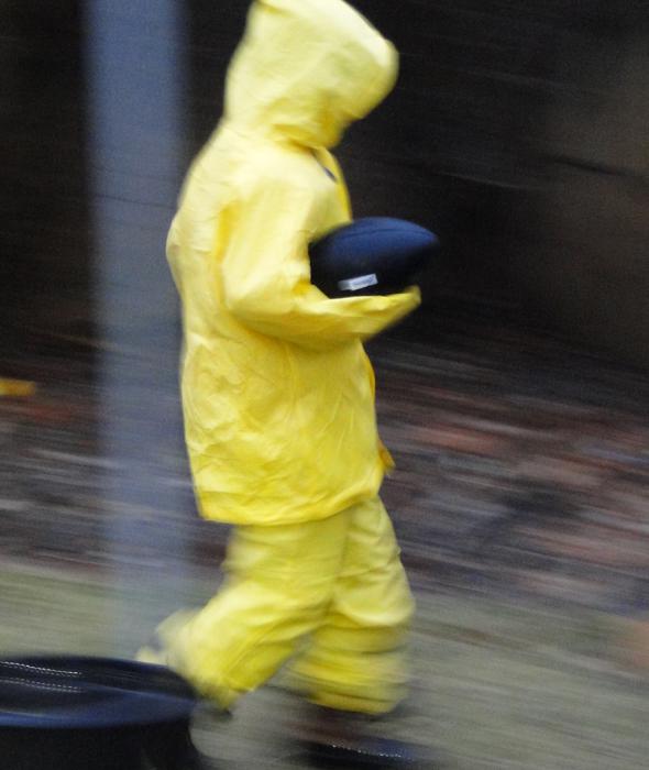 My son is having fun in the backyard playing football in the rain. Photo by Wendy Ashton.