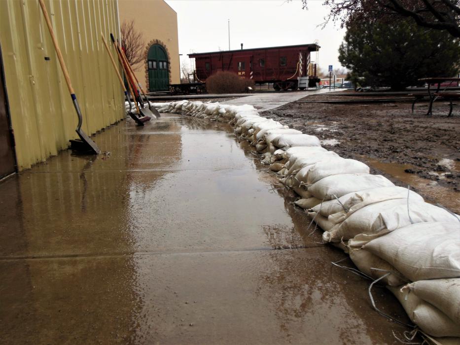 Sandbags line the front of the equipment shed annex to protect the artifacts inside.