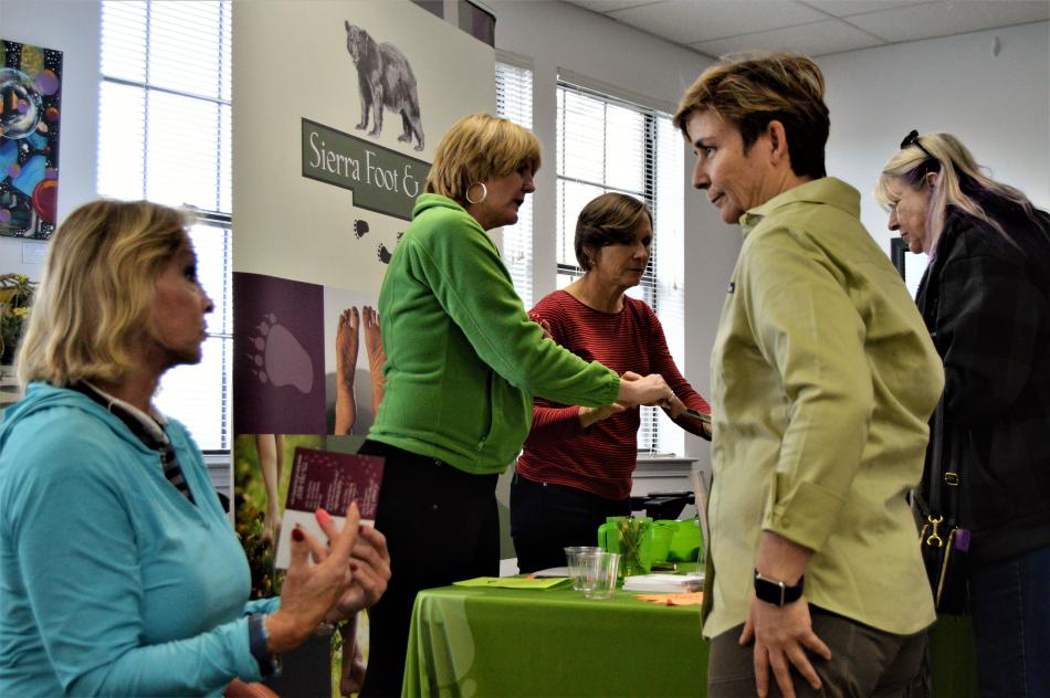 Dr. Victoria Melhuish (right) talks podiatry and wellness with a visitor to Paradise Saturday.