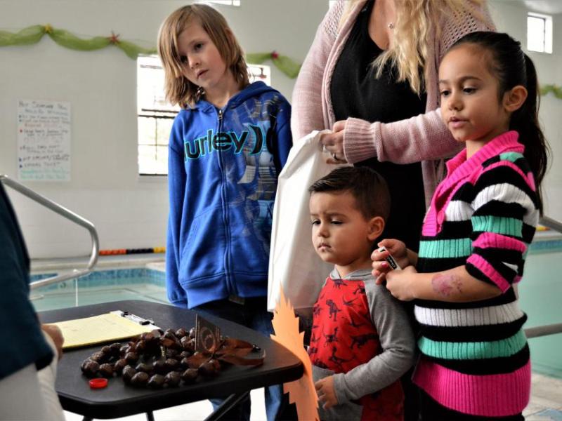 Photos by Brett Fisher. A family visits the wellness fair at Paradise Spa Saturday.