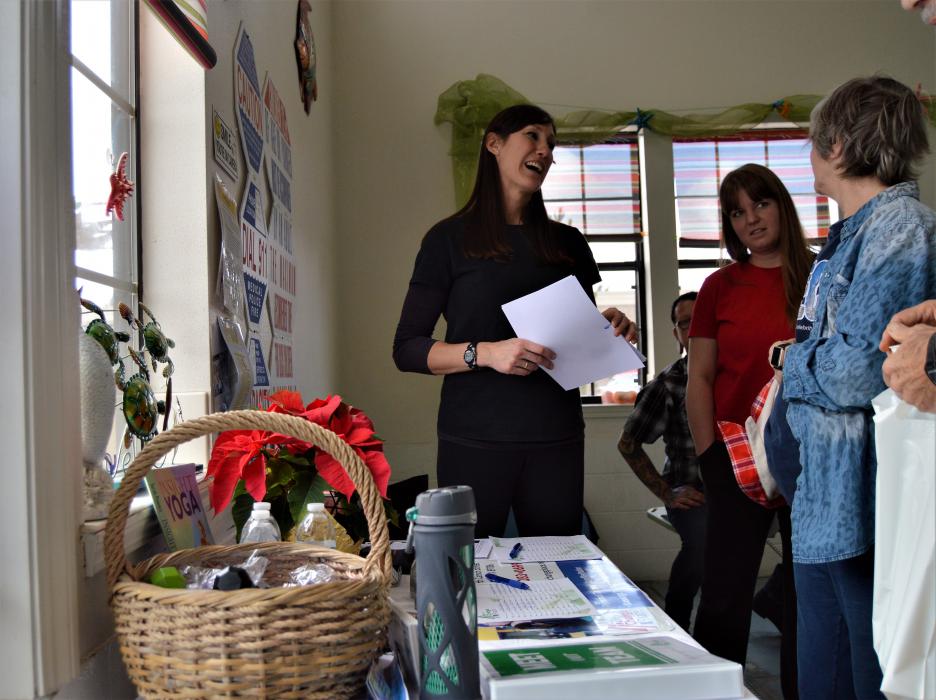 Wellness vendor discusses products/services with visitors Saturday at Paradise Spa.