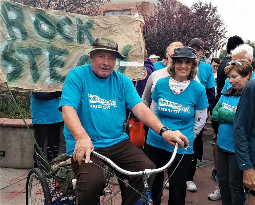 Photo courtesy Rock Steady Boxing Northern Nevada. Bob Sanders (left) on his tricycle in a parade with Rock Steady club members.