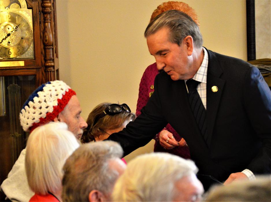 Carson City Mayor Bob Crowell awards a veteran with a certificate Wednesday.