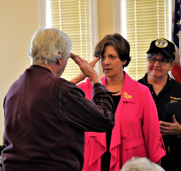NVDS Director Katherine Miller salutes a veteran Wednesday at Sierra Place.