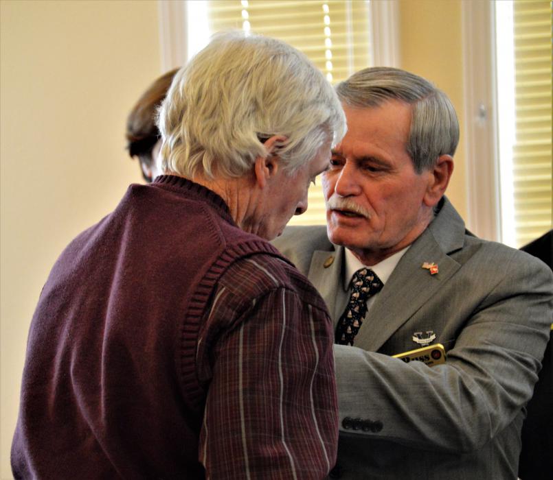 A veteran receives a service pin from the NDVS Wednesday at Sierra Place.