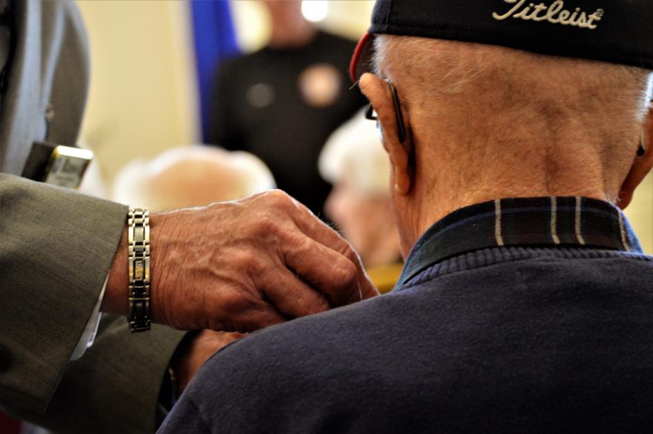 Photos by Brett Fisher. A veteran receives a service pin Wednesday at Sierra Place.