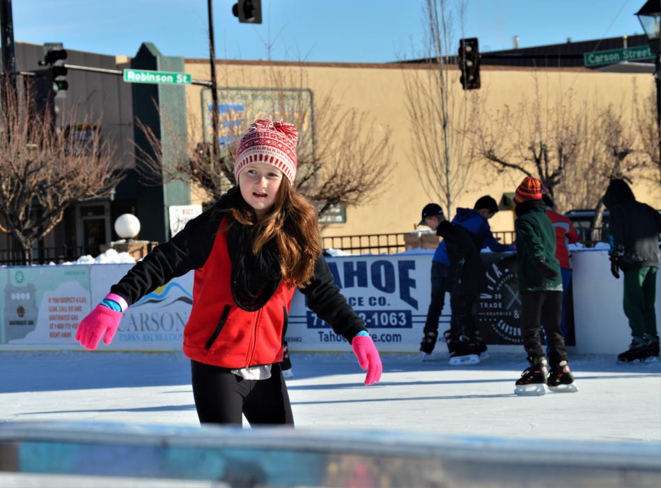 A girl skates by in the ice rink at Arlington Square Friday morning.