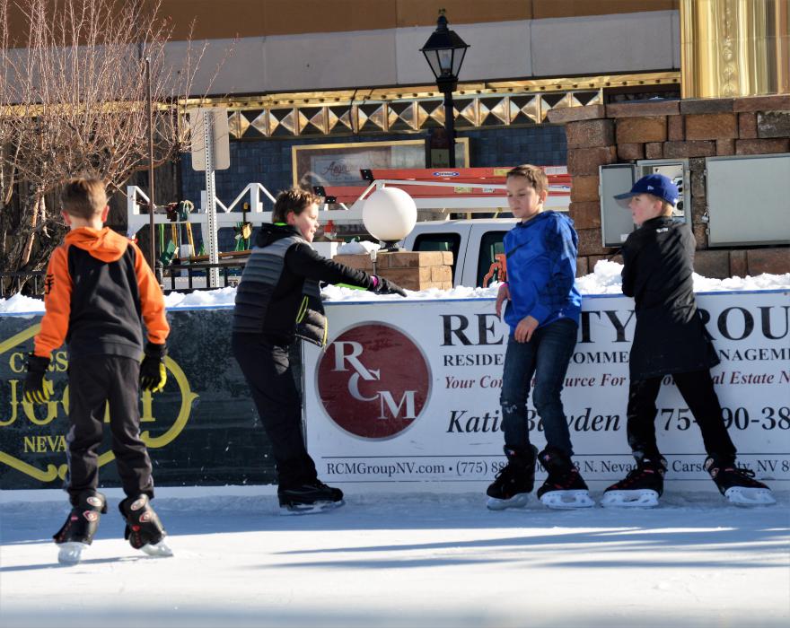 Boys congregate together on the ice rink at Arlington Square Friday morning.