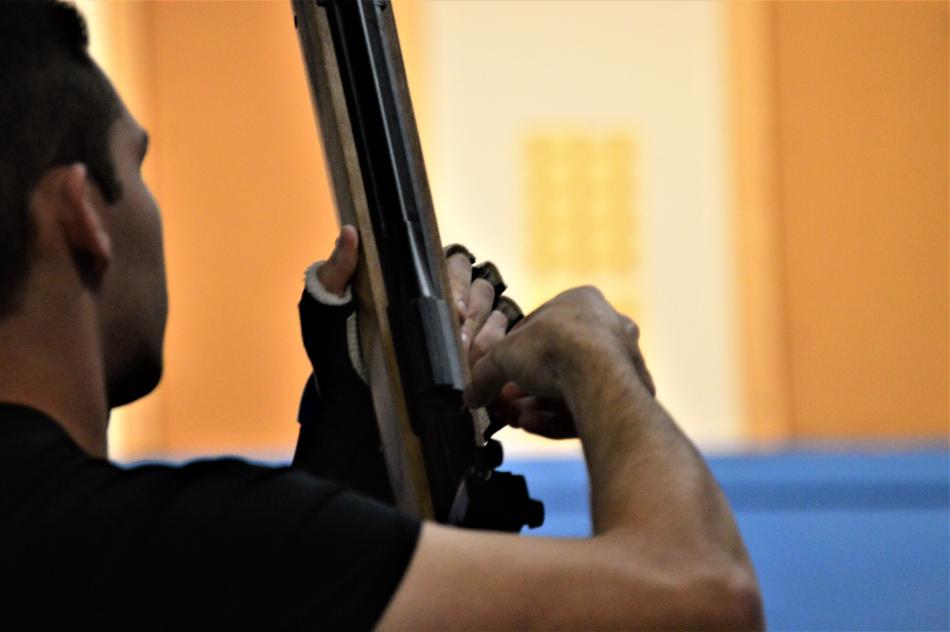 A CHS JV shooter loads pellets into his rifle Friday for the next shoot.