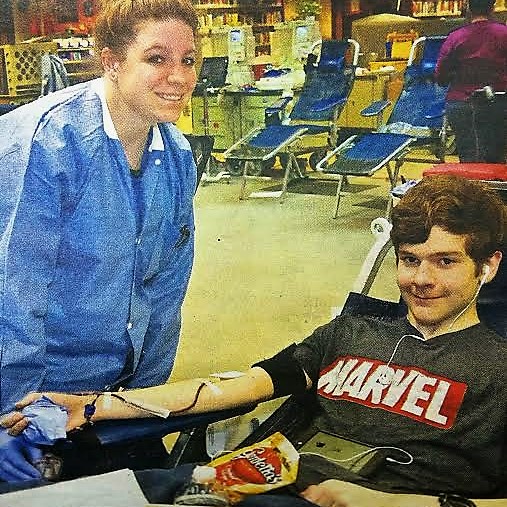 Photo courtesy CHS. NHS member Logan Smedes (right) gives blood Jan. 25.