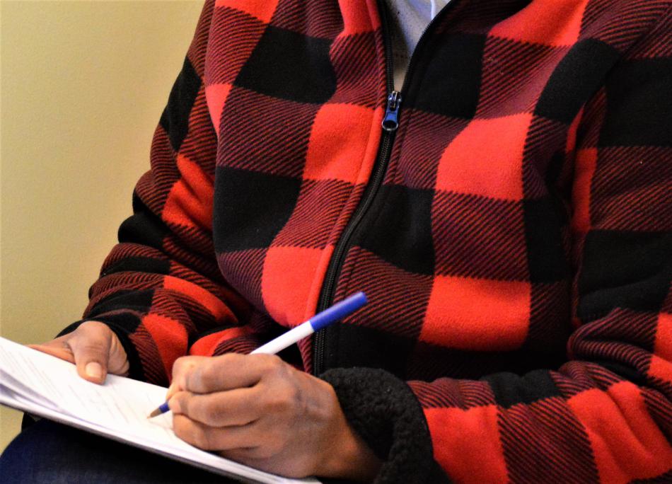 Photo by Arianna Schmidt. A client fills out paperwork inside the Mammovan.