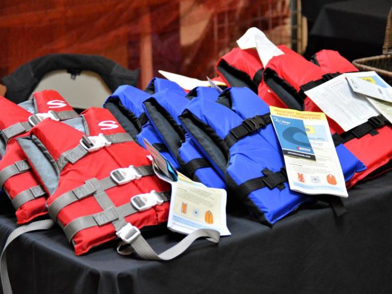 Photo by Arianna Schmidt. Youth life jackets given away at the health, wellness, safety fair.