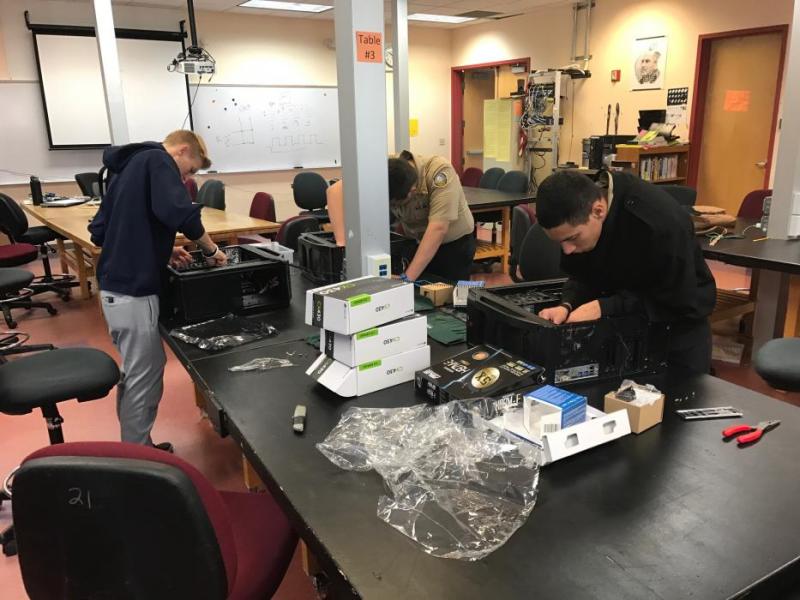 Carson High School CTE IT students assemble new computers purchased for the IT Essentials program lab.