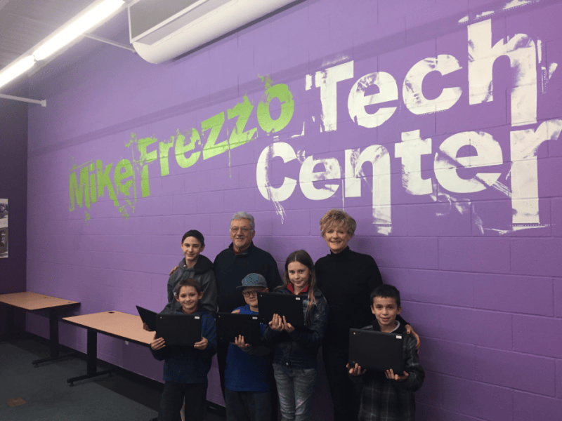 Mike Frezzo and wife Lori with kids at the Mike Frezzo Tech Center.