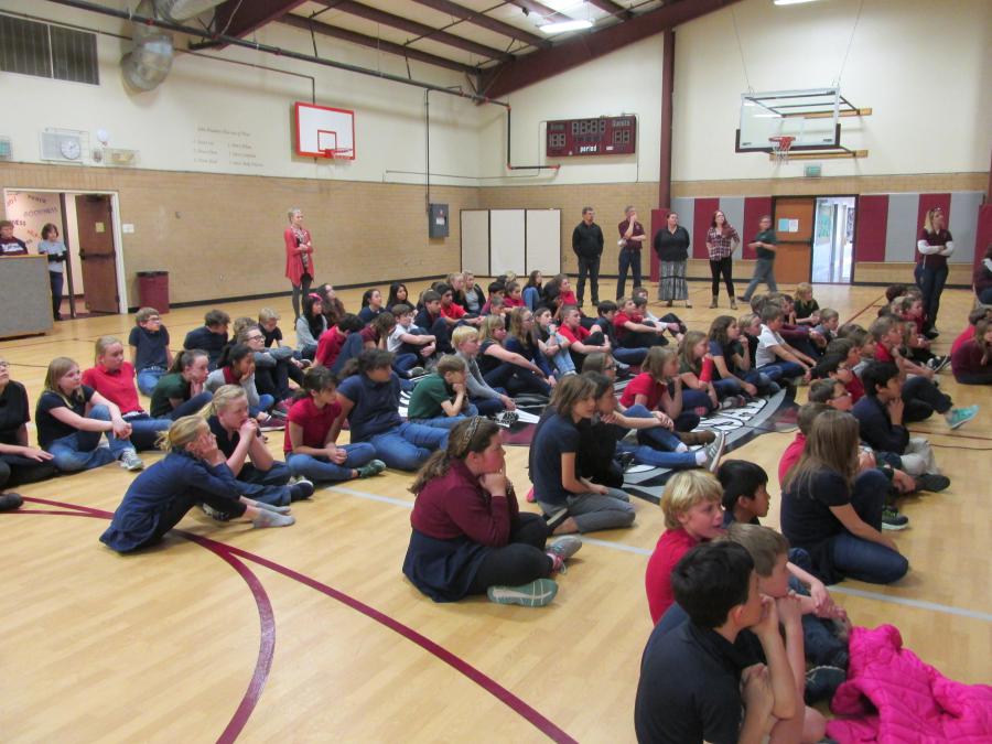 School assembly in which the school presents a check to the Children's Cancer Foundation.