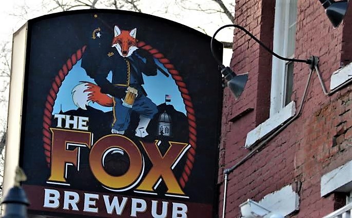 Photo by Brett Fisher. The Fox Brewpub sign out front of the St. Charles Hotel.