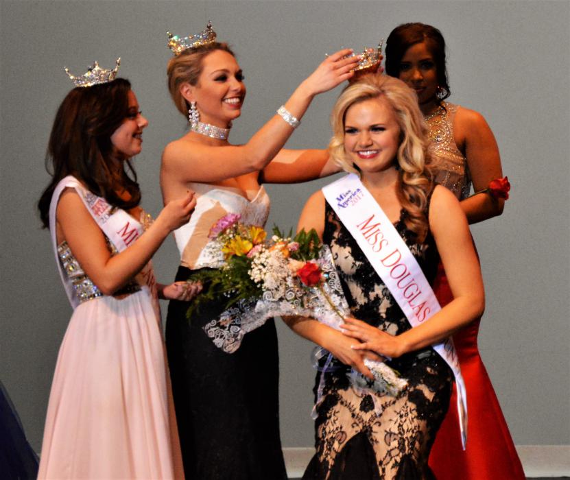 Briana Neben is crowned Miss Douglas County 2017 Saturday by Miss Douglas County 2016 Coraleigh Bales.