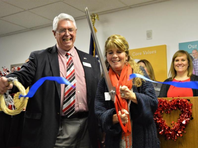 Photos by Brett Fisher. Carson City Supervisor Karen Abowd cuts the ribbon on behalf of the NRHA Home At Last program Wednesday.
