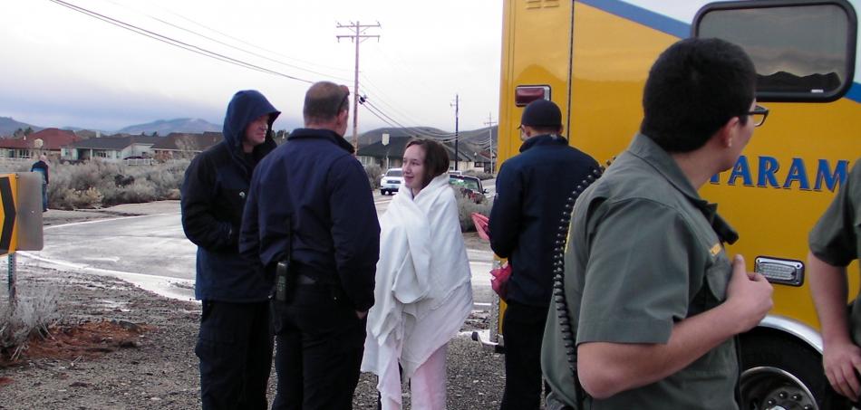 Wrapped in blankets, a very cold Kaitlin Schultz, 13, talks with Carson City Fire Department personnel.