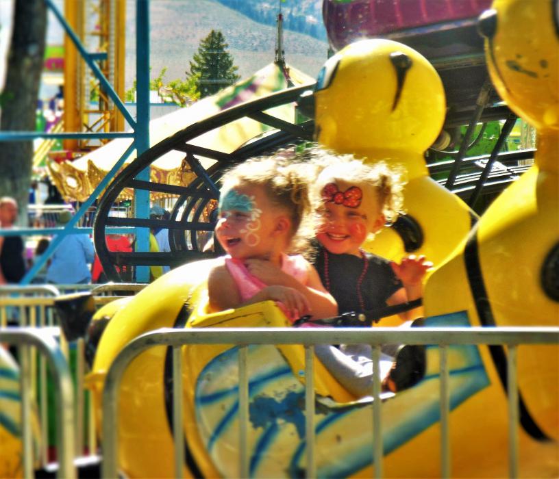 Photo by Brett Fisher. Children on a carnival ride at Mills Park last summer.