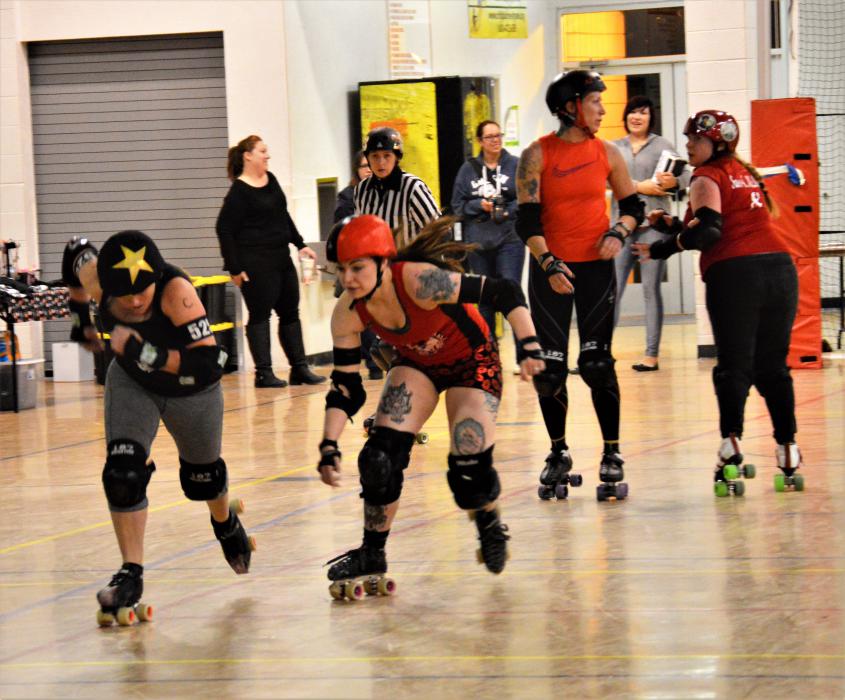 One skater chases after another to stop a score.