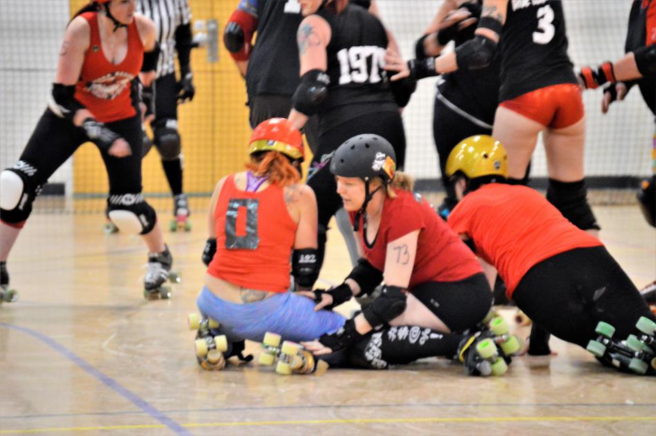 Skaters collect themselves after falling to the floor together during a jam.