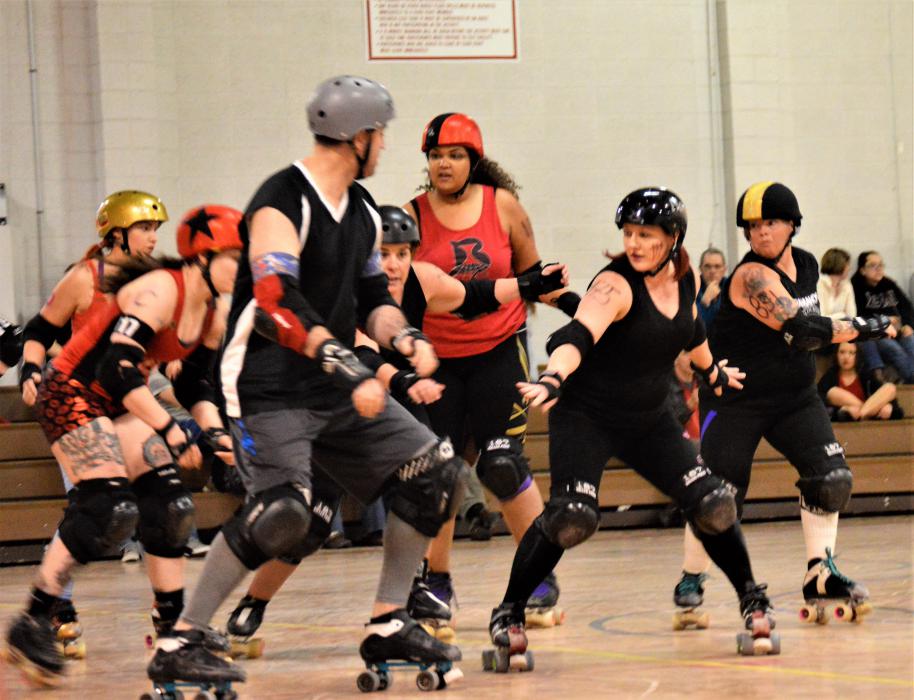 Skaters looking to block for a jammer.
