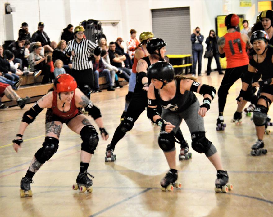 Photos by Brett Fisher. Skaters go head-to-head Sunday night during a Valentine's roller derby fundraiser.