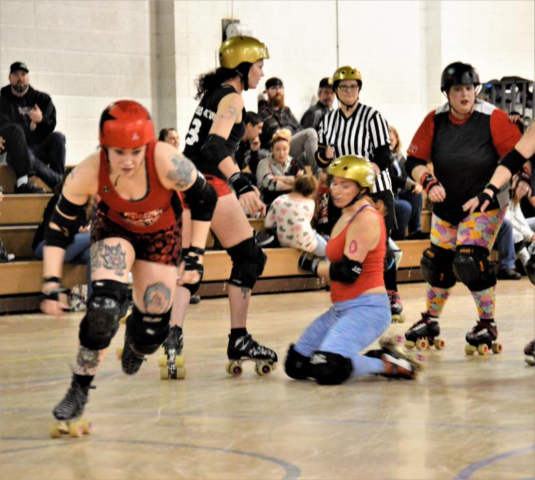A jammer breaks lose from a jam Sunday during a roller derby fundraising scrimmage.