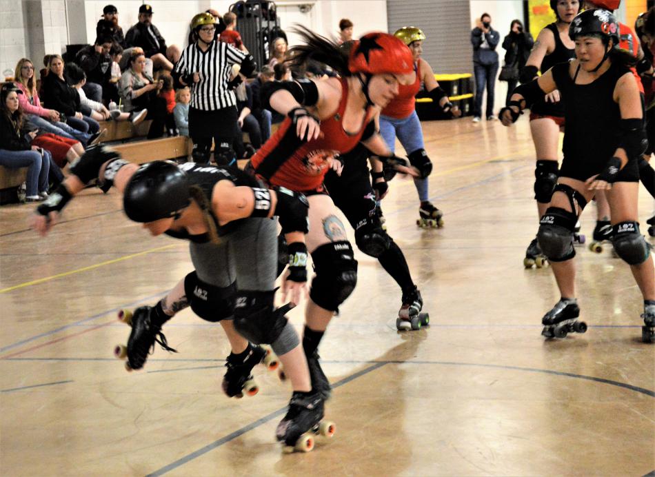 Skaters get tangled up on their way to the floor Sunday night at the Carson Community Center.