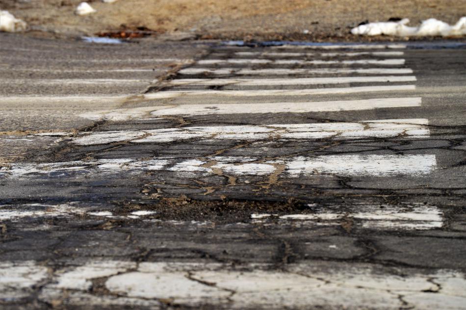 Photos by Brett Fisher. Asphalt depression and deterioration in a crosswalk at Saliman and Colorado.