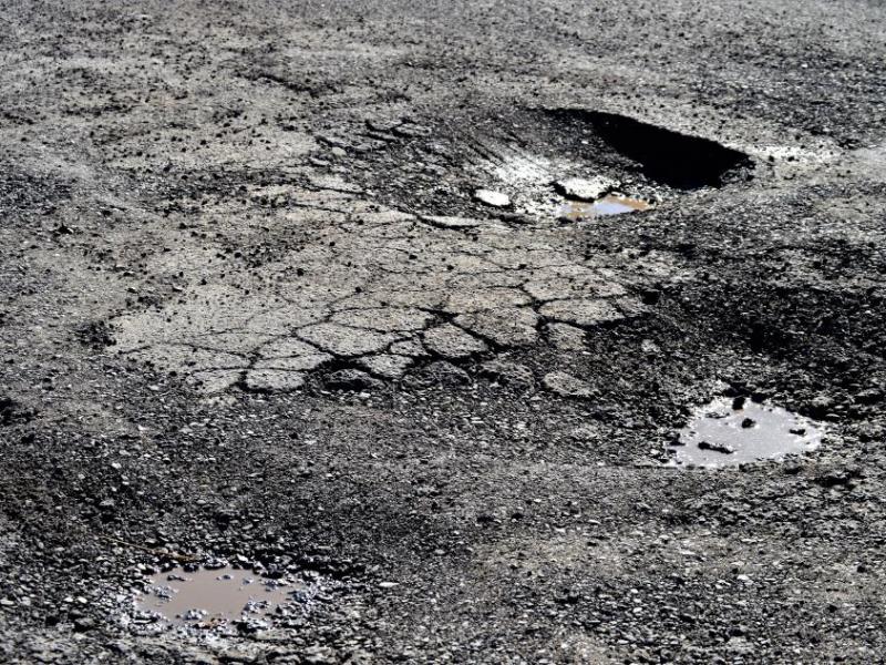 Potholes near the U.S. Post Office at Little and Roop.