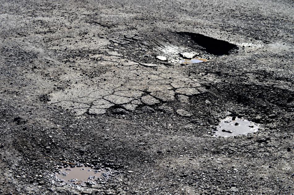 Potholes near the U.S. Post Office at Little and Roop.