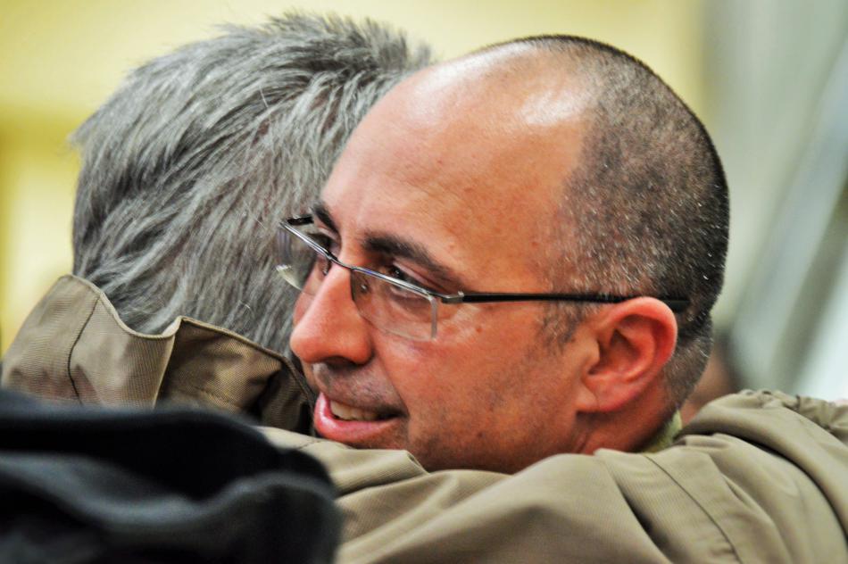 Robert Glass hugs his dad Friday afternoon at RTIA.