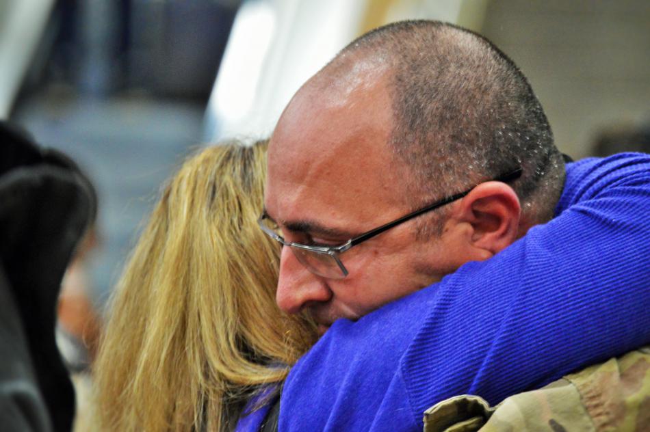Robert Glass hugs his mom Friday after arriving at RTIA.