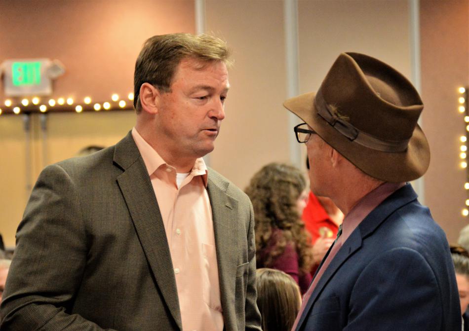 U.S. Sen. Dean Heller, R-NV, talks with a luncheon guest Wednesday.