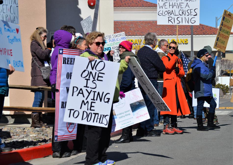 Protesters line the street behind the Gold Dust West Casino in Carson City.