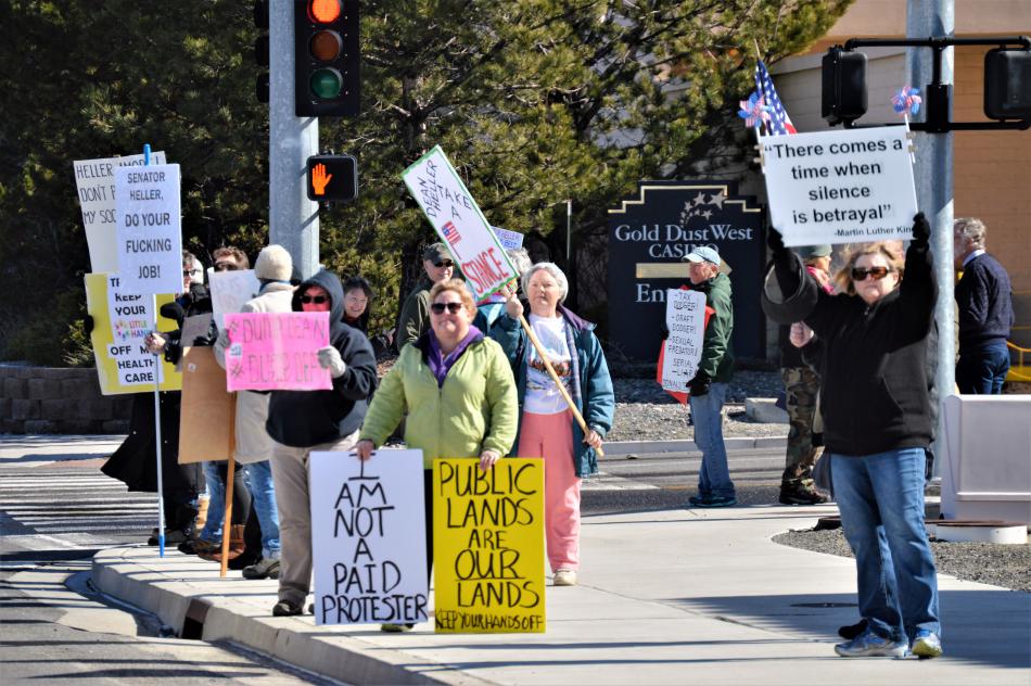 Protesters with signs along East William Street near the Gold Dust West.