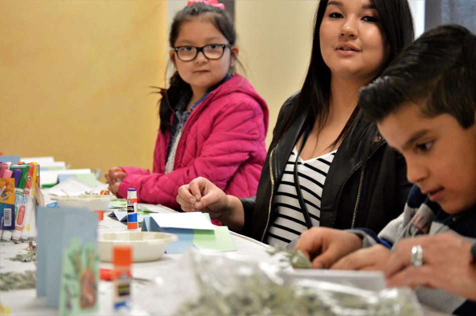 A family engages in a coloring activity Saturday at the Nevada State Museum.
