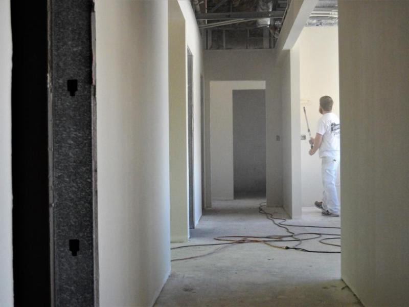 Photos by Brett Fisher. A painter in the front hallway of the new See Center.