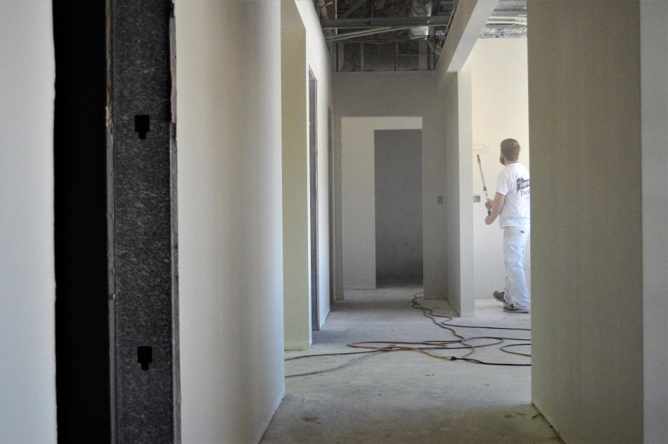 Photos by Brett Fisher. A painter in the front hallway of the new See Center.