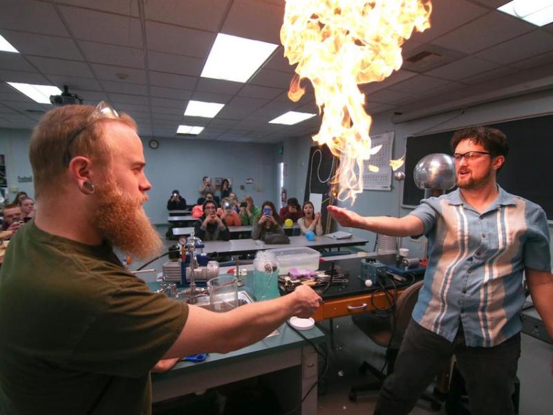 Physics professor Thomas Herring, right, and lab assistant Jordan Dargert give high school students a visual science lesson.