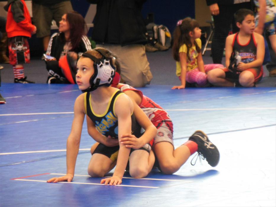 Youth wrestlers await the whistle to begin another round Saturday at the MAC.