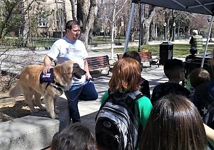 A service dog trainer teaches children the importance of working dogs.
