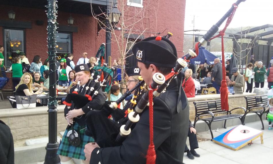 Bagpipers play in front of The Fox Brew Pub Friday.